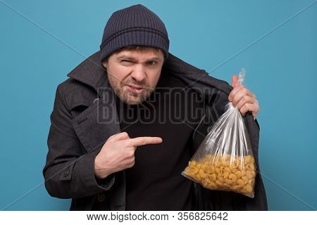 Smuggler Selling Food. Dealer In Hat And Coat Offering To Buy Pasta. Deficit Of Food Because Of Pani