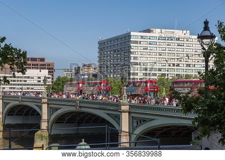 London, United Kingdom- June 2019: Westminster Bridge With Four Red Double Decker Buses, In London.
