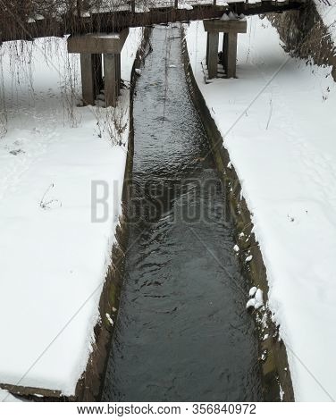 Urban Stream In Winter. The Lybid River (kyiv, Ukraine) In The Snow.