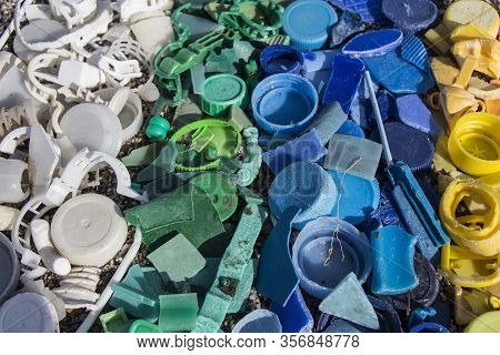 Close-up Of Plastic Trash Spilled On The Beach, Dirty Sea Sandy Shore, Environmental Pollution, Ecol