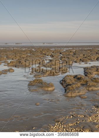 Aerial View Of Horizon Over Sea, With Mounds Of Mud In The Foreground, National Park And Unesco Worl