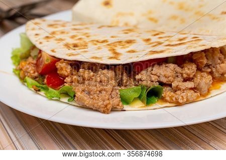 Fajitos With Minced Meat Vegetables In A Corn Tortilla On A Blue Plate Dark Wooden Background. Fast