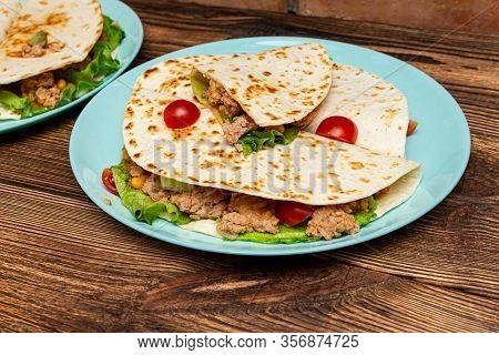 Fajitos With Minced Meat Vegetables In A Corn Tortilla On A Blue Plate Dark Wooden Background. Fast