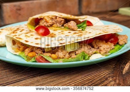 Fajitos With Minced Meat Vegetables In A Corn Tortilla On A Blue Plate Dark Wooden Background. Fast 