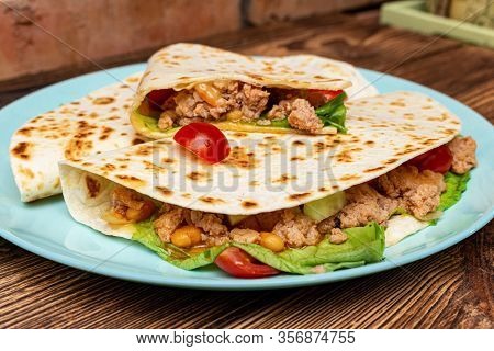 Fajitos With Minced Meat Vegetables In A Corn Tortilla On A Blue Plate Dark Wooden Background. Fast 