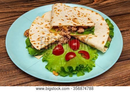 Fajitos With Minced Meat Vegetables In A Corn Tortilla On A Blue Plate Dark Wooden Background. Fast