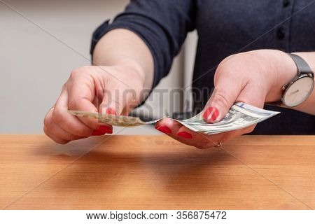 Womans Hands Counting Hundred Dollar Bills Over The Table. Selective Focus