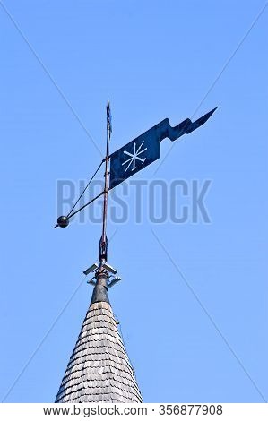 Vintage Metal Rooftop Spire Aka Spile On The Wooden Building Roof On Blue Sky In Sunny Day, Modern T
