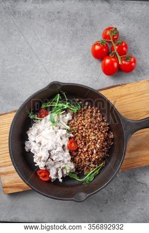 Beef Stroganoff In Cream And Buckwheat And Cherry Tomatoes In Pan