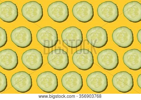 Cucumber Regular Pattern. Circles Of Green Cucumber On A Yellow Background. Zozulya Cucumber
