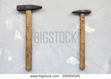 Two Old Rusty Hammers On Gray Background, Carpentry Concept, Copy Space