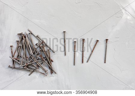 Old Rusty Nails On Gray Background, Carpentry Concept, Copy Space