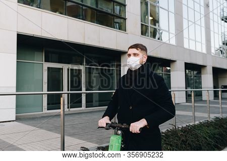 Caucasian Young Man Near His Office Wearing Surgical Face Mask To Protect From Coronavirus Covid-19