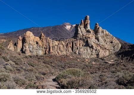 View Of Roques De García Unique Rock Formation With Famous Pico Del Teide Mountain Volcano Summit In