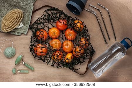 Mandarins In Green Net Bag Zero Waste Concept Flat Lay On Wooden Table