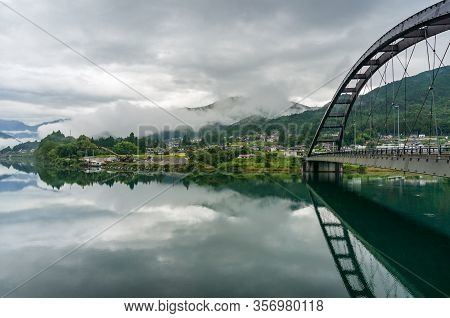 Bridge Across The River In Kiso Valley With Rural Village View Landscape. River Bridge In Japanese C