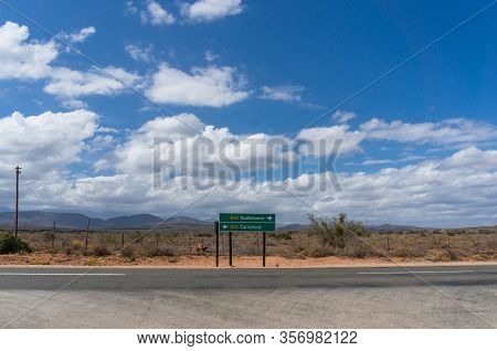 Direction Sign On R62 Highway In South Africa With Directions To Oudtshoorn And Calitzdorp Towns And