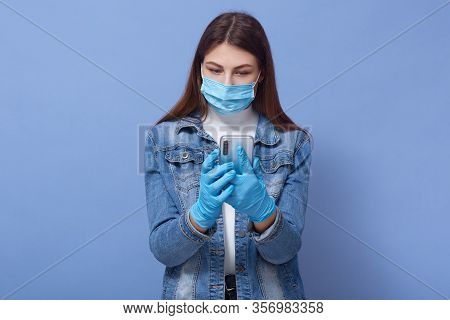 Close Up Portrait Of Young Brunette Woman Wearing Medical Face Mask And Disposable Blue Gloves, Typi
