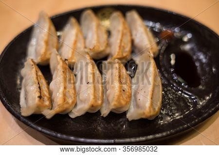 Traditional Japanese Gyouza Deep Fried Dumplings On Dark Plate. Japanese Cuisine Snack