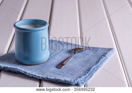 Healthy Organic Fresh And Delicious Creamy Yogurt On White Wooden Tabke.