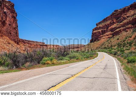 Us Road 128 Winding Through Utah Desert Between Red Cliffs On Abeautiful Day Of Spring. Scenic Drive