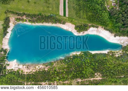 Ariel Top View Of An Old Flooded Lime Quarry With Turquoise Water