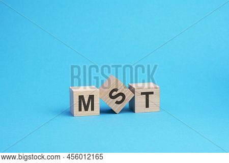 Mst Text On Wooden Blocks, Financial Business Concept, Blue Background. Mst - Short For Marketing So
