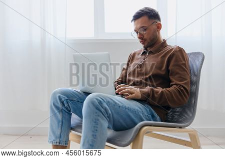 Modern Profession Offer. Pensive Young Man In Eyewear Typing Report For Work Project Think About Rig