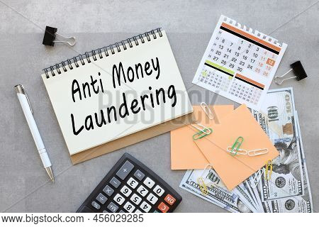 Anti-money Laundering Aml Open Notepad On Gray Background Near Orange Stickers