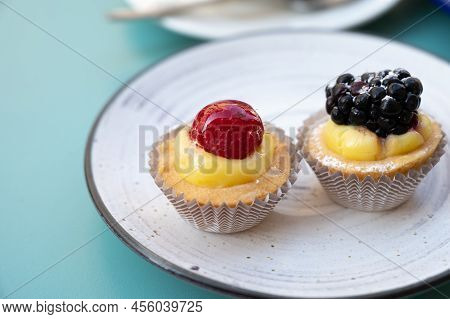 Mini Fruit Italian Cupcakes With Fresh Berries On Board