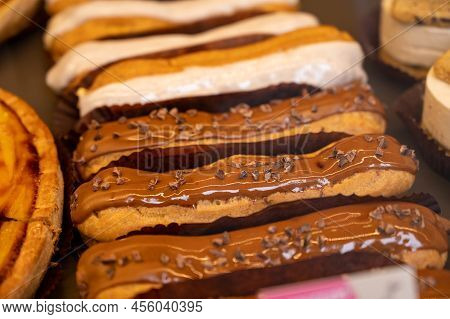 French Sweet Dessert Filled With Cream Fresh Baked Eclers Cakes  Close Up