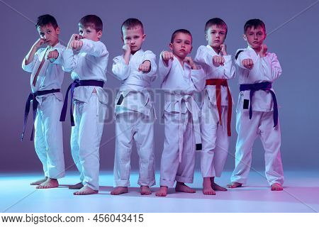 Group Of Kids, Preschool Age Boys, Taekwondo Athletes In White Doboks Standing Together Isolated On 