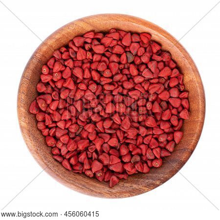 Annatto Seeds In Wooden Bowl, Isolated On A White Background. Achiote Seeds, Bixa Orellana. Natural 