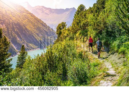 Alpine Track And Two Hikers At Vivid Blue Mountain Lake In Summer Alps. Speicher Zillergrundl Dam, Z