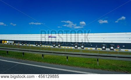 Id Logistics - View Of A Logistics Park With Warehouse, Loading Hub And Semi Trucks With Cargo Trail
