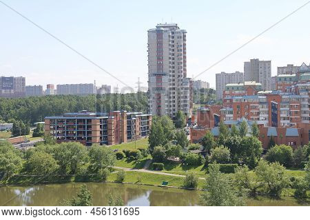Lush Greenery Of Trees And Lawns Around The Pond In The Park, Urban Landscape Park.