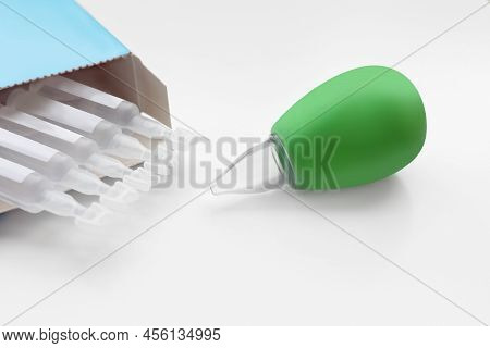 Package With Single Dose Ampoules Of Sterile Isotonic Sea Water Solution And Nasal Aspirator On Whit