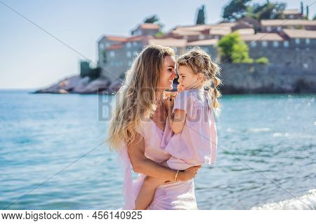 Mother And Daughter Tourists On Background Of Beautiful View St. Stephen Island, Sveti Stefan On The