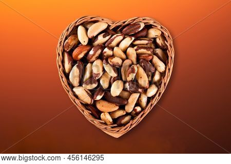 Brazil Nut In Heart Basket Top View With Colorful Gradient Background.