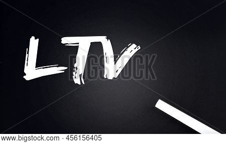 Ltv Text On A Black Chalkboard With Piece Of Chalk