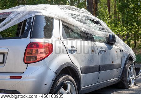 Shot, Damaged Cars During The War In Ukraine. The Vehicle Of Civilians Affected By The Hands Of The