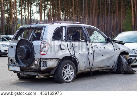 Shot, Damaged Cars During The War In Ukraine. The Vehicle Of Civilians Affected By The Hands Of The