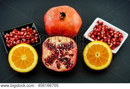 Sliced Red Pomegranate On A Black Slate