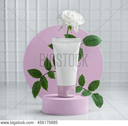 Cream tube mockup with rose. Pink color background for branding and packaging presentation. beauty and spa concept