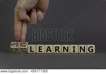 Blended Or Hybrid Learning Symbol. Businessman Turns Cubes, Changes Words Blended Learning To Hybrid