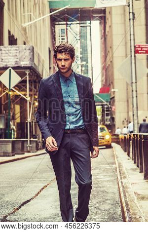 Raining, Blurry, Moody Feel. European Businessman Traveling In New York. Wearing Blue Suit, A Guy Wi