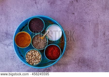 Indian Spice Box On Wooden Background With Copy Space,cardamom, Turmeric, Chilli Powder, Salt,mustar