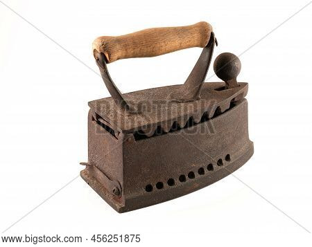 Antique rusty smoothing iron isolated on white background