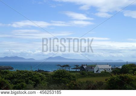 Anglesey, Wales Landscape Of Sea And Snowdonia.  Beautiful Summer Scene With Blue Skies.
