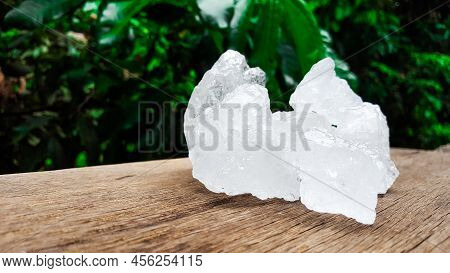 White clear alum cubes on brown woodplank concept for beauty and medical industrial.